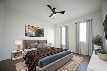 Bedroom with ceiling fan and wood-style flooring at West Row Lofts and Townhomes in Birmingham, AL